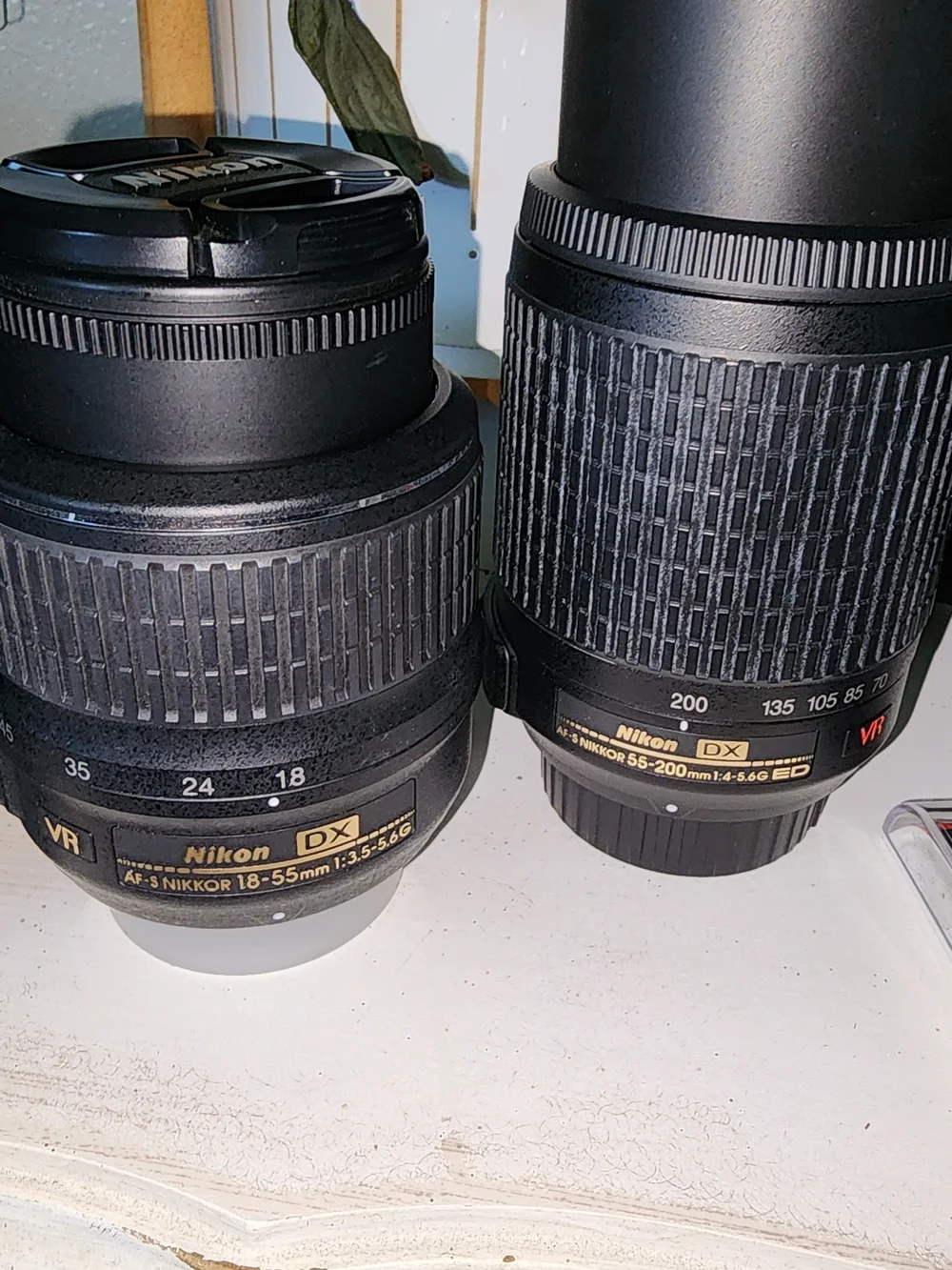 Nikon black DSLR Camera Body with Two Black Zoom Lenses